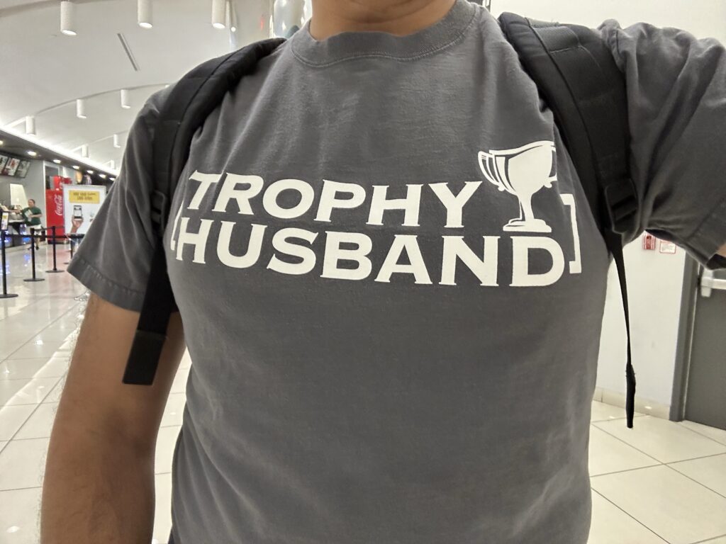 A t-shirt that says "TROPHY HUSBAND"