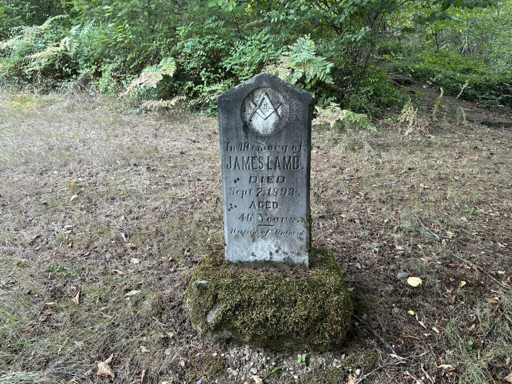 The grave of James Lamb, died 1893, with a large freemason logo on the headstone.