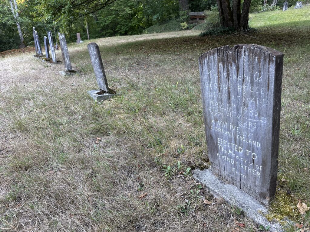 An old 1883 grave with a wooden, painted headstone. I guess this should be called a headplank?