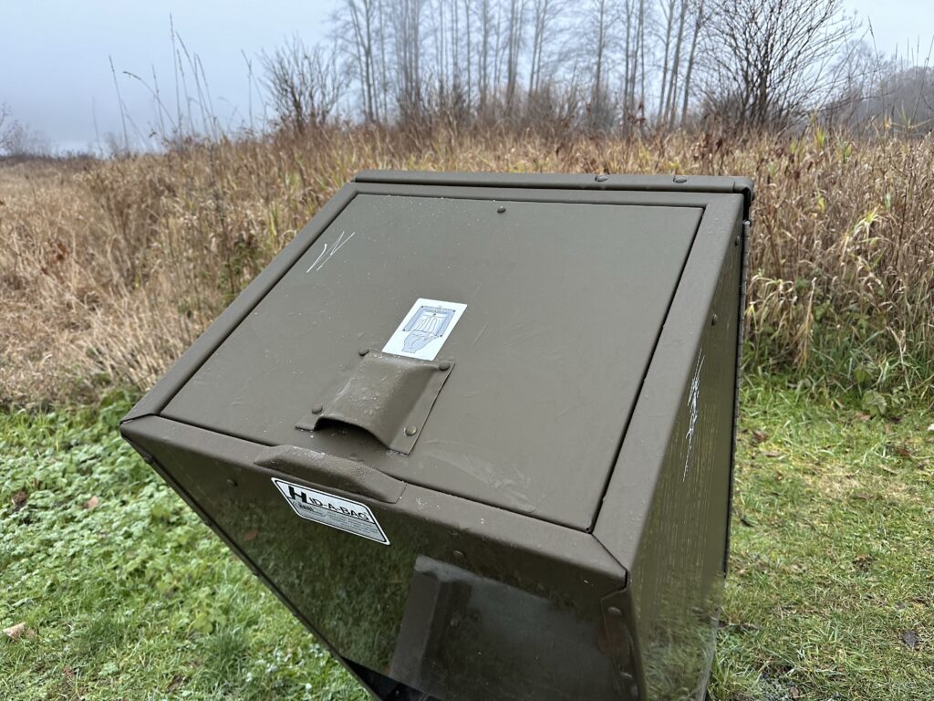 A photo of a Canadian park garbage container, with a bear-proof lid that tends to get frozen stuck at night 