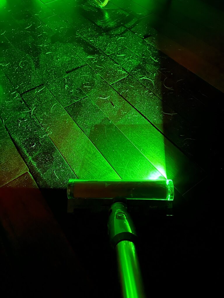 A picture of my living room's floor, as illuminated by the vaccum's laser. At the bottom of the picture is the clean part where the vaccum went, and all around it is a mix of sand, dirt, and dog hair. It's absolutely horrible.