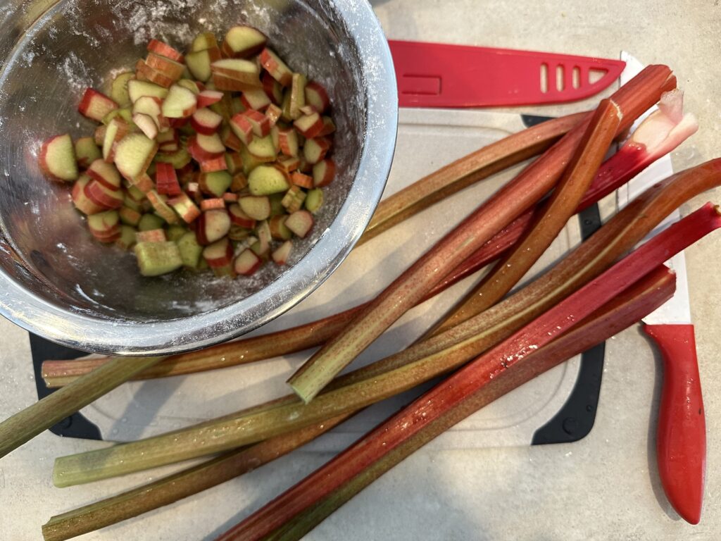 Rhubarb sticks being cut in little pieces