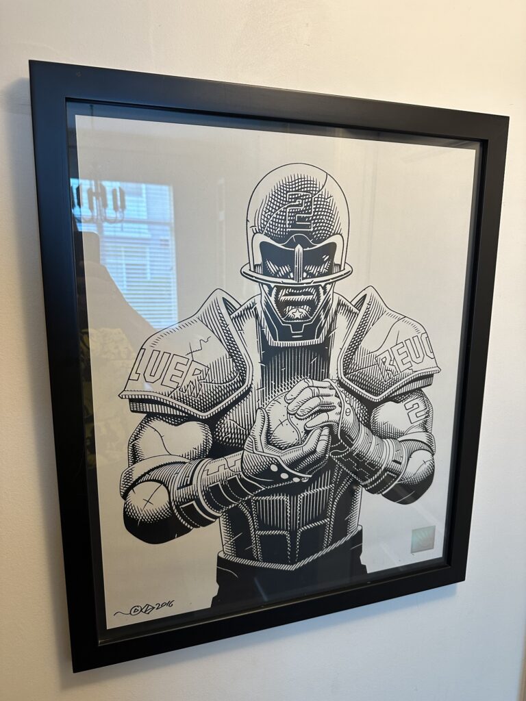 A Speedball 2: Brutal Deluxe art print, showing a member of the Revolver team in full gear holding a ball.