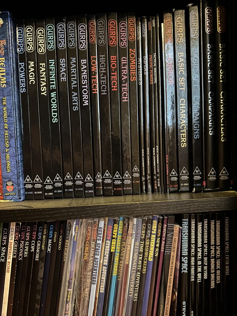 A shelfie featuring parts of my GURPS collection. Fourth edition books are on the top shelf, third edition and earlier are on the bottom shelf.