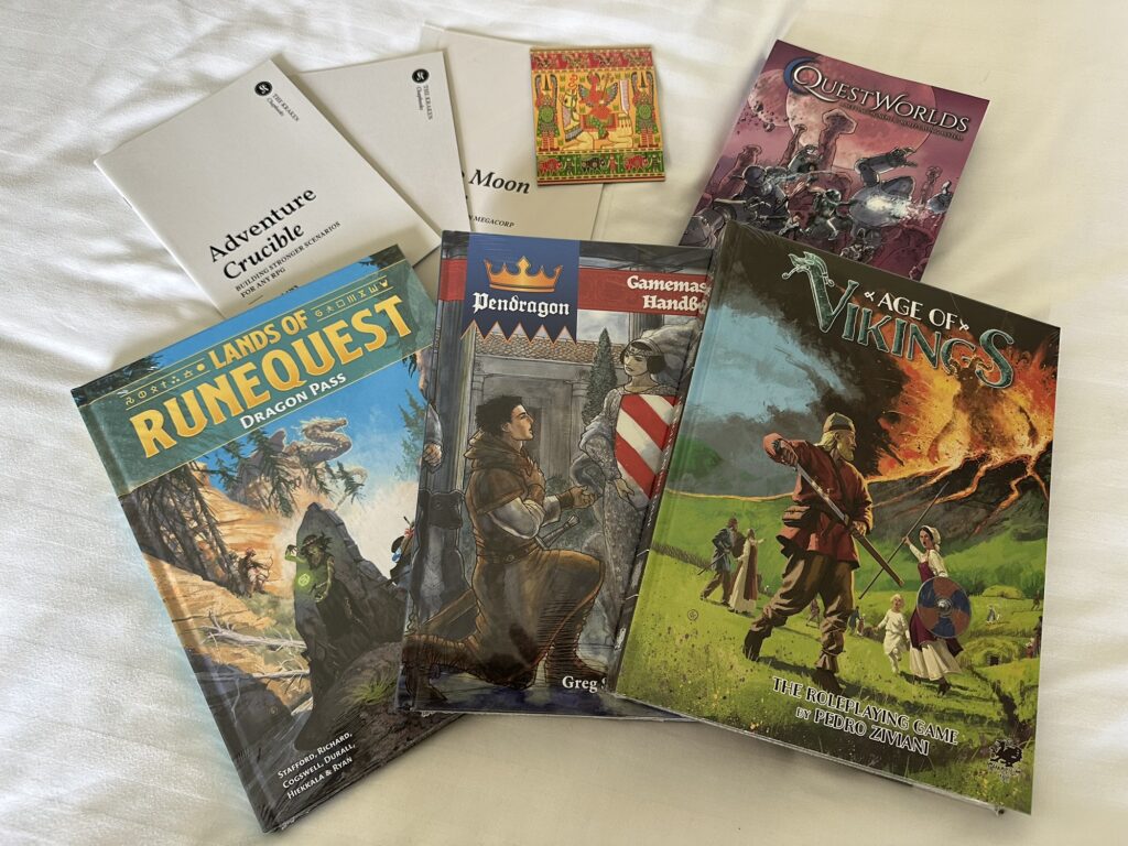 Some loot from ChaosiumCon UK: a few Kraken chapbooks, a magnet illustrated by Katrin Dirim, the QuestWorlds book, Lands of RuneQuest: Dragon Pass, Pendragon: Gamemaster Handbook, and Age of Vikings hardcovers