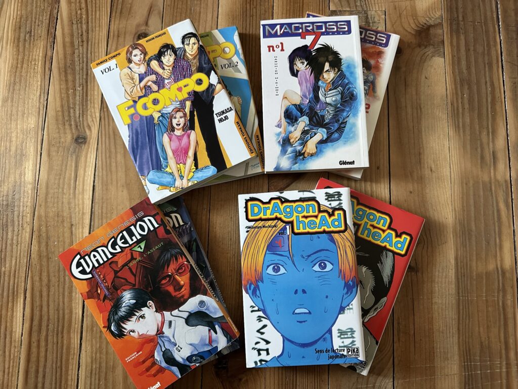 A few manga: "F.Compo", "Macross 7", "Evangelion", and "Dragon Head".