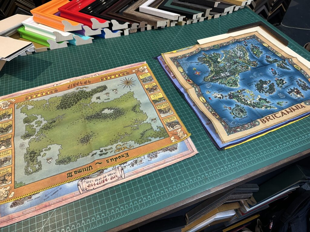 Ultima cloth maps on a table with some various frame style samples around