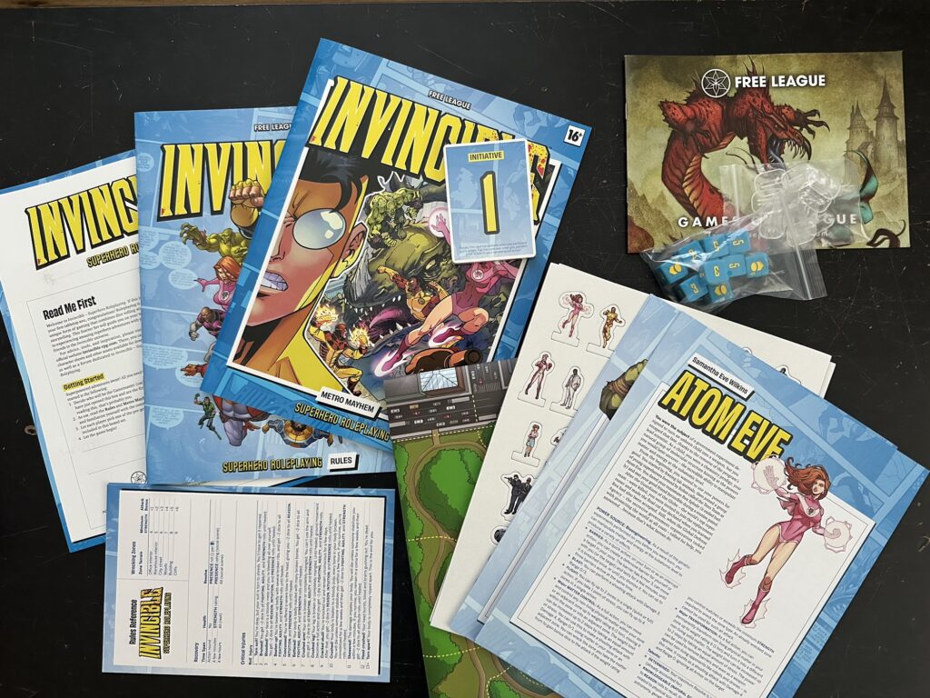 Contents of the Starter Set, including some dice, some initiative cards, a bunch of standees, lots of character sheets, a rules booklet, an adventure booklet, and a few other tidbits. This looks like a Free League Starter Set alright!