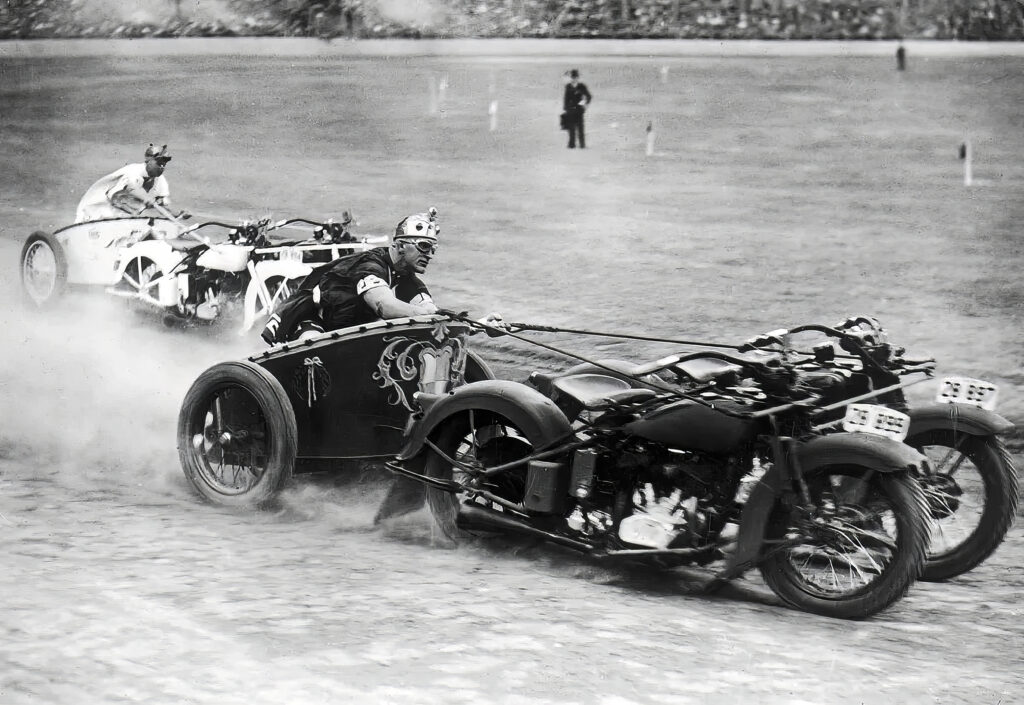 Some historically accurate Bronze Age elite warriors on their chariots, pulled by motorbikes, racing around a stadium.