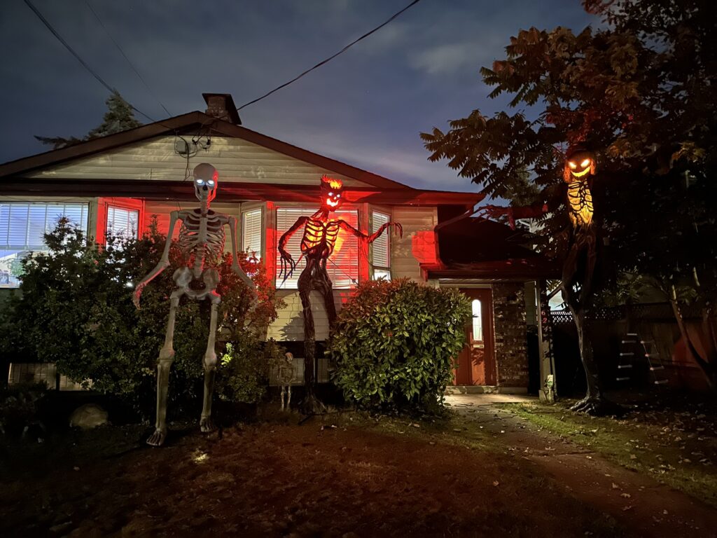 A house with not one, not two, but THREE of these giant skeleton thingies. Two are lit from inside and have pumpkin heads.