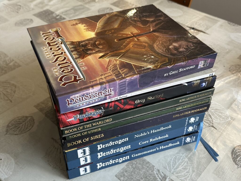 The  pile of Pendragon books I'm using to prepare for my game:
- Great Pendragon Campaign
- Pendragon rulebook (5.2 edition)
- Book of the Warlord
- Book of Uther
- Book of Sires
- Pendragon Noble's Handbook (6h edition)
- Pendragon Core Rulebook (6th edition)
- Pendragon Gamemaster's Handbook (6th edition)