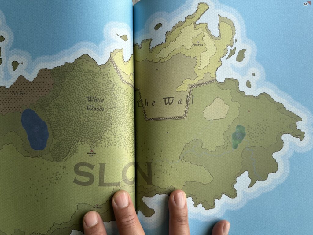 A page spread of the Argan Argar Atlas book, featuring Slon. It's hard to tell but the printing is a bit too dark, the blacks aren't too black, and the contrast is a bit poor. Basically average POD quality.